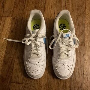 Nike Sneakers (low cut, white leather with a blue swoosh).